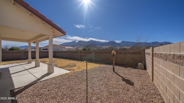 view of yard featuring a mountain view and a patio area