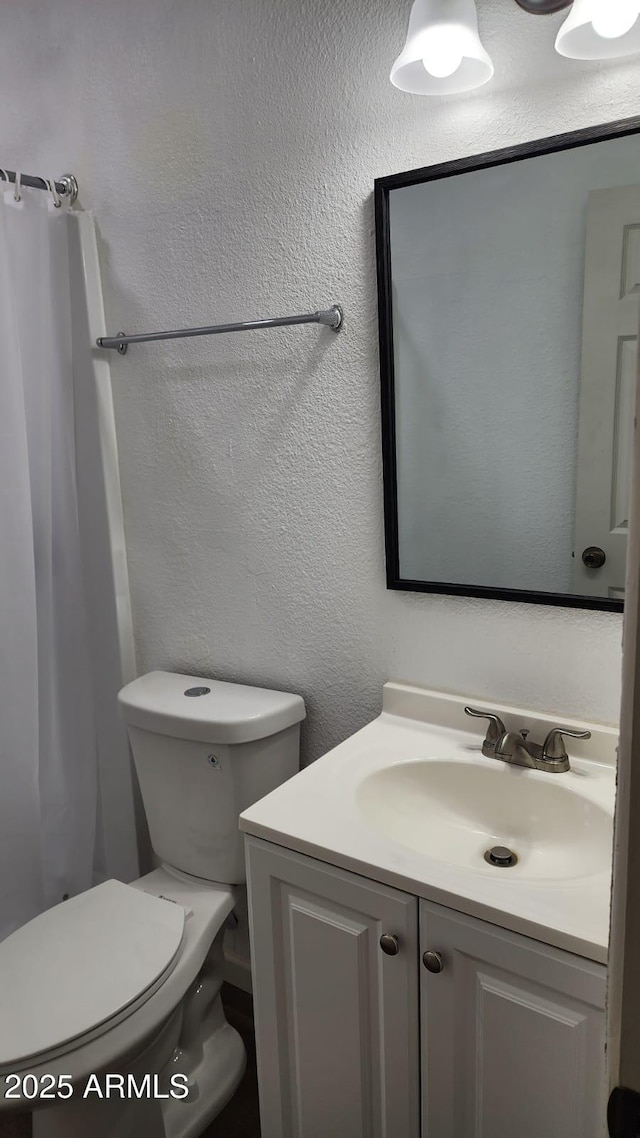 bathroom featuring vanity and toilet