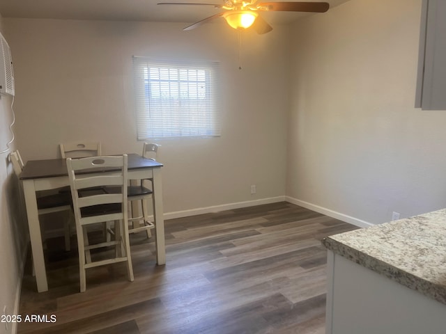 unfurnished dining area featuring ceiling fan and dark hardwood / wood-style flooring