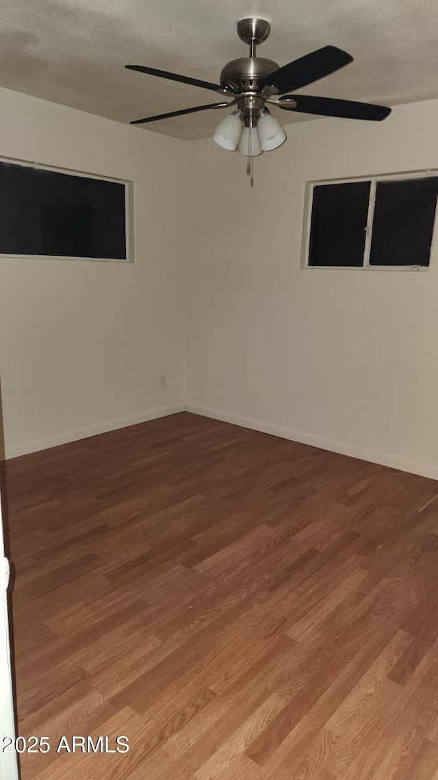 unfurnished room featuring ceiling fan and hardwood / wood-style floors