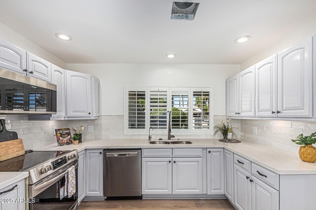 5333 E Sheena Dr, Scottsdale, AZ 85254 - kitchen with stainless steel appliances, a sink, tasteful backsplash, light countertops, and recessed lighting