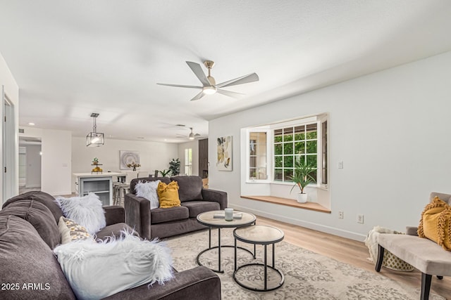 5333 E Sheena Dr, Scottsdale, AZ 85254 - living area with light wood-type flooring, a ceiling fan, and baseboards
