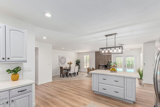 5333 E Sheena Dr, Scottsdale, AZ 85254 - kitchen featuring light countertops, light wood finished floors, baseboards, open floor plan, and recessed lighting