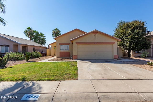 view of front of property featuring a garage and a front yard