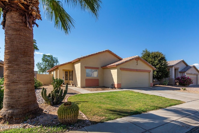 view of front of home featuring a garage and a front lawn