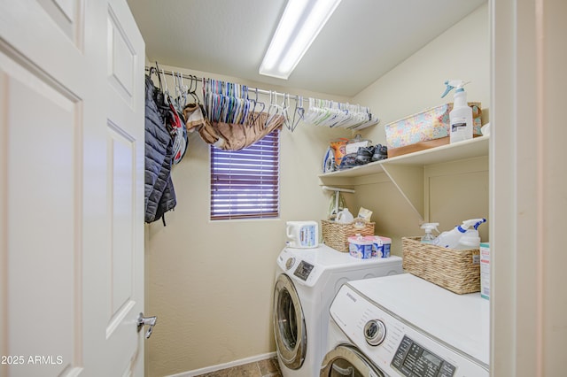 clothes washing area featuring separate washer and dryer, laundry area, and baseboards