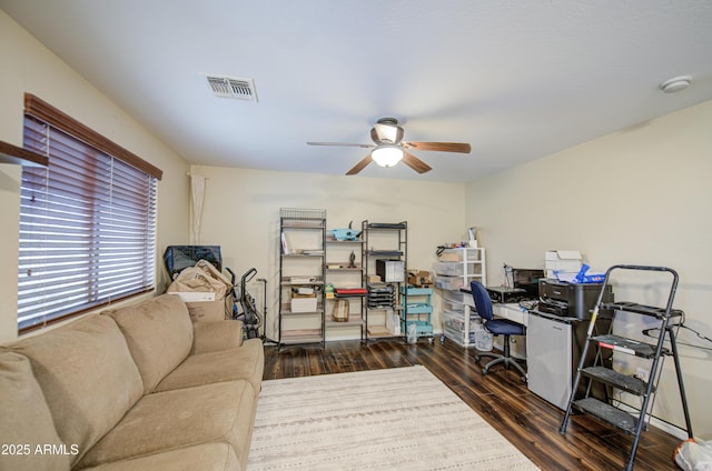 office space featuring wood finished floors, a ceiling fan, and visible vents