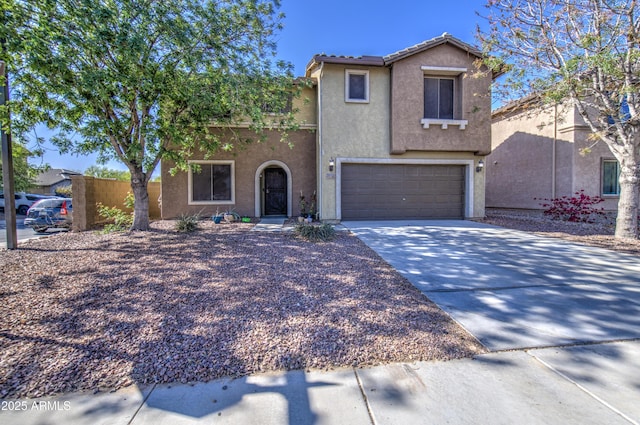 view of front of house featuring driveway, stucco siding, a tiled roof, and an attached garage