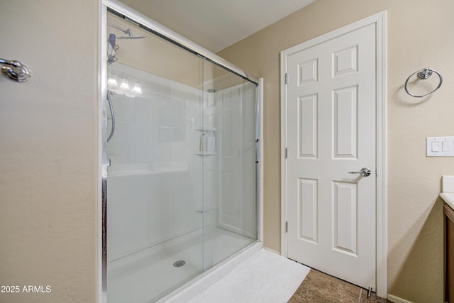 bathroom with a shower stall, vanity, and tile patterned flooring