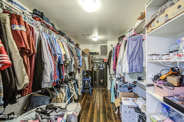 walk in closet featuring wood finished floors and visible vents