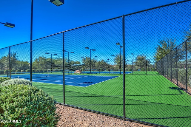 view of tennis court with fence