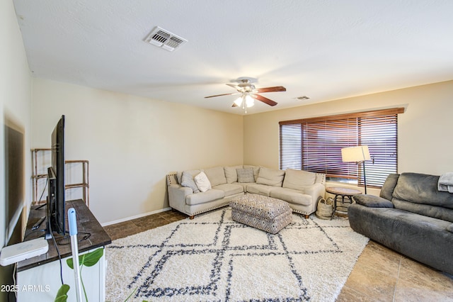 living room with a ceiling fan, visible vents, and tile patterned flooring