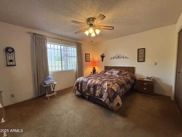 carpeted bedroom featuring ceiling fan and a textured ceiling