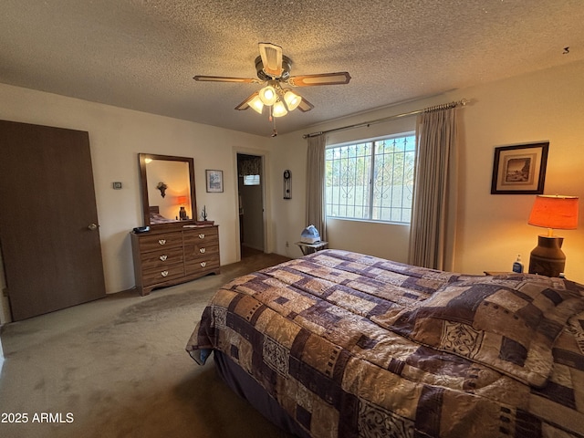 carpeted bedroom with a textured ceiling and ceiling fan