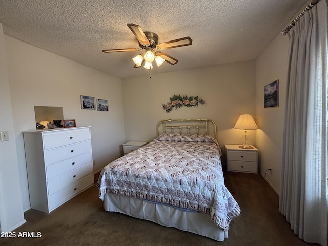 carpeted bedroom featuring ceiling fan and a textured ceiling