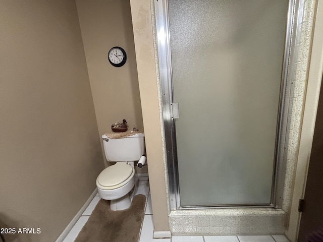 bathroom featuring tile patterned flooring, an enclosed shower, and toilet