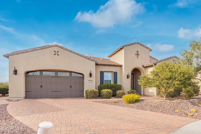 mediterranean / spanish-style home with a garage