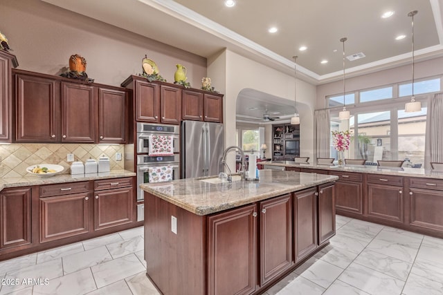 30056 N 129th Ave, Peoria, AZ 85383 - kitchen with sink, backsplash, light stone counters, stainless steel appliances, and a center island with sink