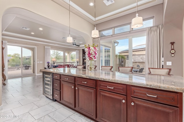 30056 N 129th Ave, Peoria, AZ 85383 - kitchen with pendant lighting, ornamental molding, beverage cooler, and a kitchen breakfast bar