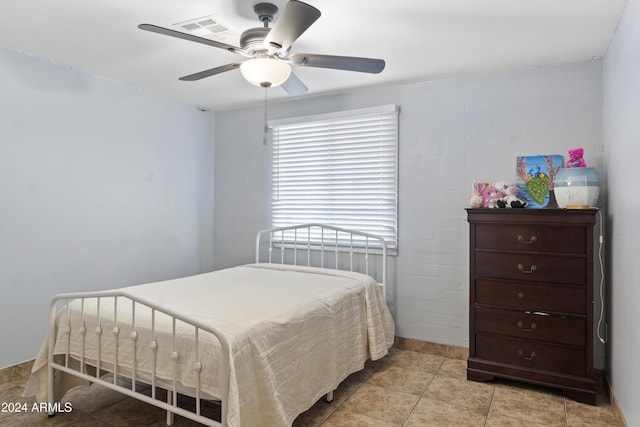 tiled bedroom with ceiling fan