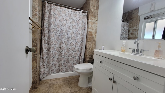 bathroom with tile patterned flooring, vanity, and toilet