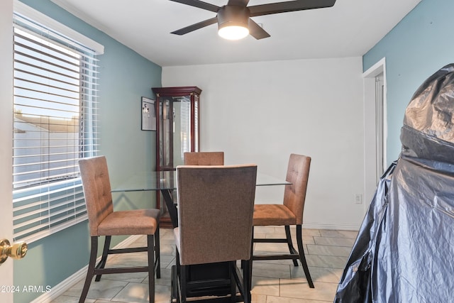 tiled dining space featuring ceiling fan