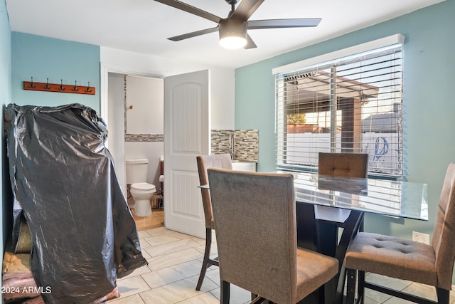 dining space featuring ceiling fan and light tile patterned floors