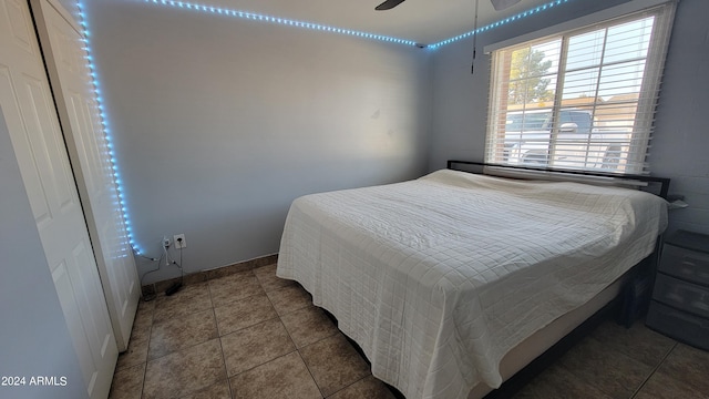 bedroom featuring tile patterned flooring, a closet, and ceiling fan