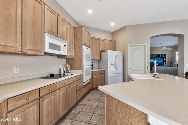 kitchen with ceiling fan, sink, white appliances, light tile patterned floors, and light brown cabinetry