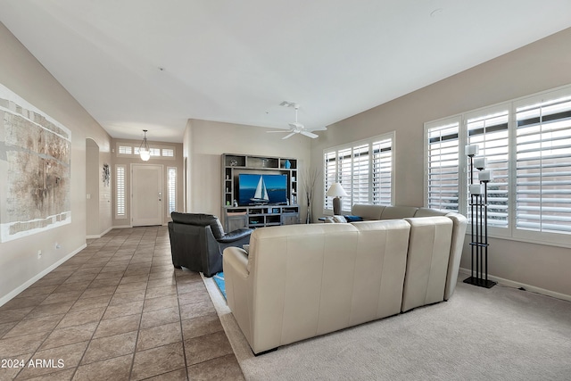 tiled living room with ceiling fan