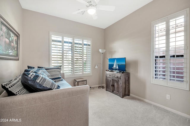 carpeted living room featuring ceiling fan and plenty of natural light