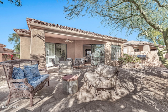 rear view of property featuring ceiling fan, a patio area, and an outdoor hangout area