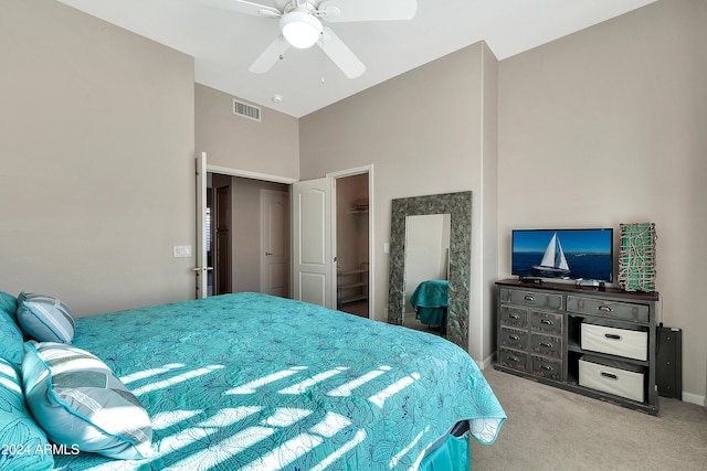 bedroom featuring ceiling fan, a closet, and light carpet