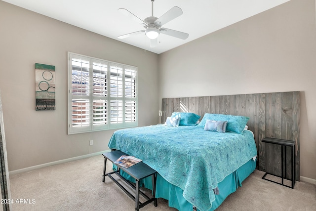 bedroom with ceiling fan and light colored carpet