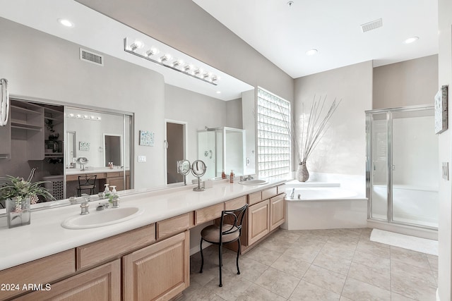 bathroom featuring tile patterned floors, vanity, and shower with separate bathtub