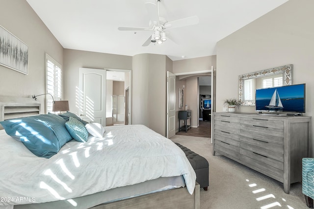 carpeted bedroom featuring ceiling fan and connected bathroom