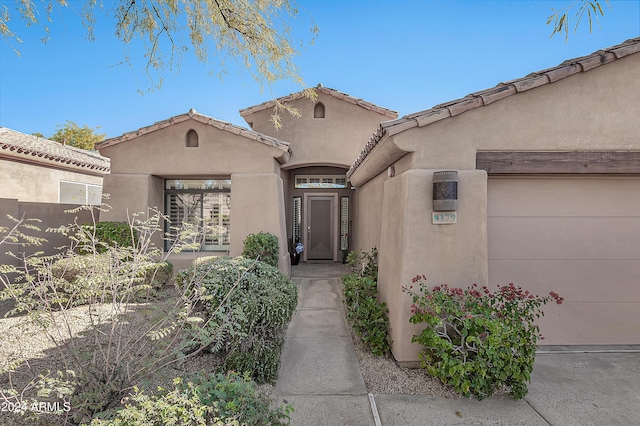 view of exterior entry featuring a garage