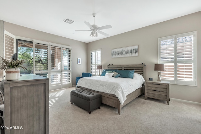 carpeted bedroom featuring ceiling fan and access to outside