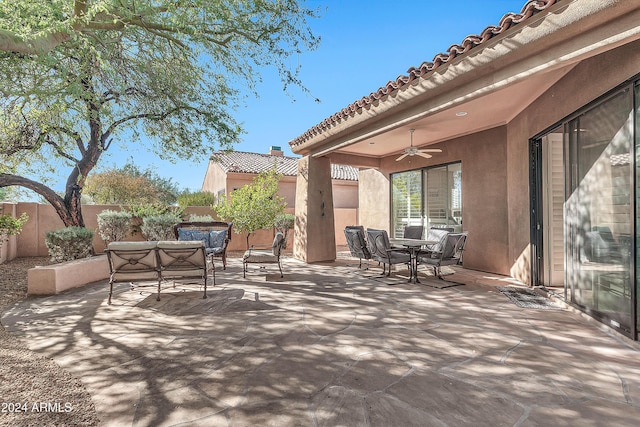 view of patio / terrace with ceiling fan and an outdoor living space