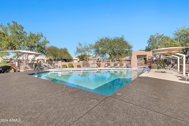 view of swimming pool with a patio