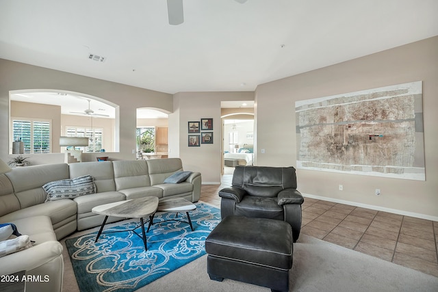 tiled living room featuring ceiling fan