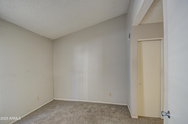 carpeted spare room with a textured ceiling