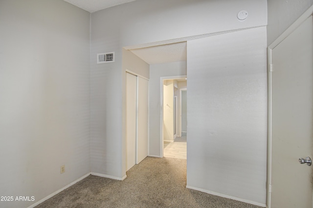 hallway featuring carpet flooring