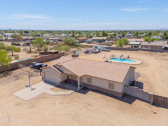 aerial view of property and surrounding area featuring a pool