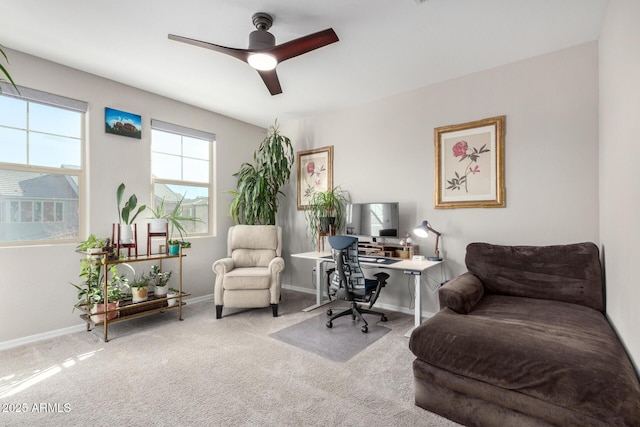 carpeted office space featuring ceiling fan