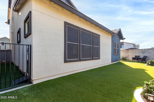 view of side of home with a yard