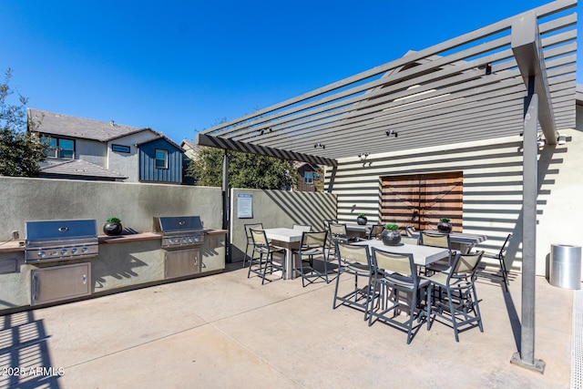 view of patio with area for grilling and a pergola