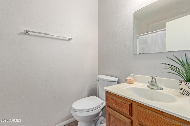 bathroom featuring toilet and vanity