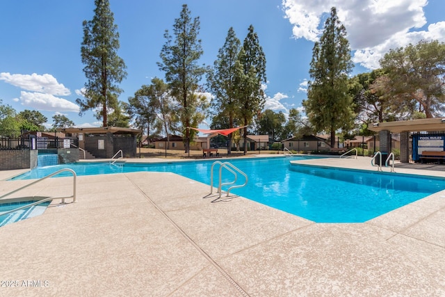 community pool featuring a patio and fence