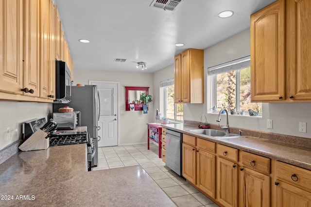 kitchen with sink, stainless steel appliances, and light tile patterned floors